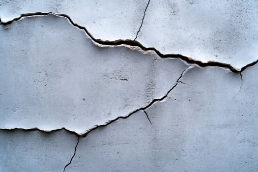 Cracking concrete wall showing signs of deterioration and damage photo