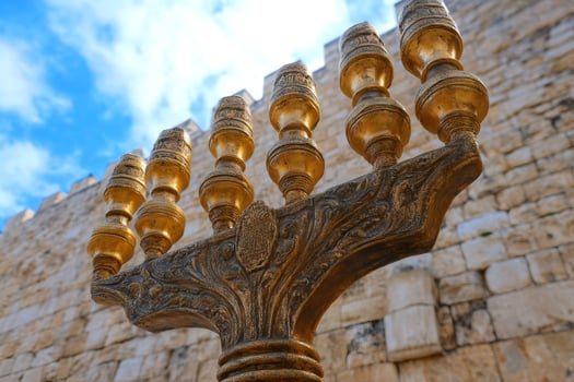 Golden menorah shining in front of the western wall in jerusalem photo