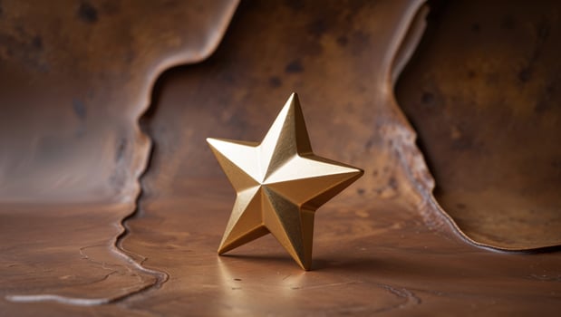 A golden star with sharp edges on a textured brown background photo