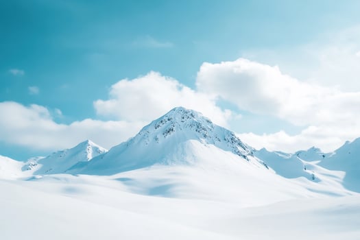 Snow-Covered Mountain Peak Against a Blue Sky photo