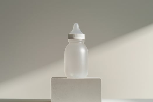 Sleek design of a baby bottle placed on a minimalistic pedestal photo