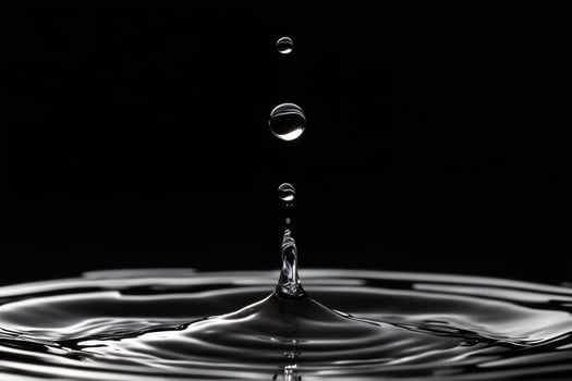 Water Droplet Impact and Ripple Formation on Black Background photo