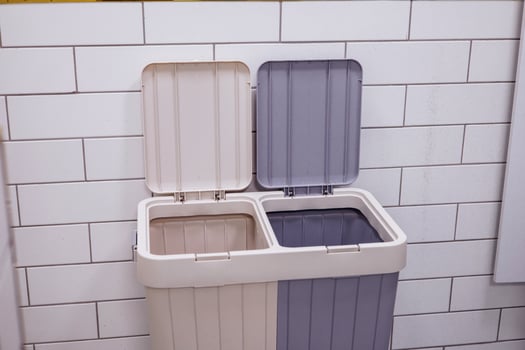 A Modern kitchen waste bin for recycling and trash with dual compartments photo