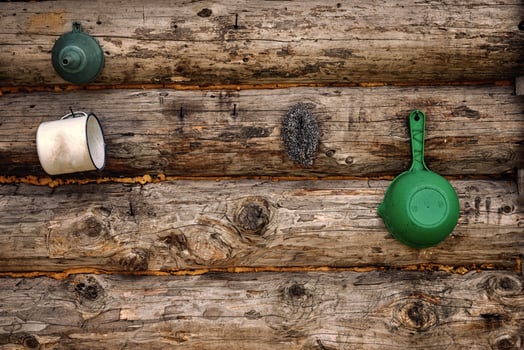 A wooden wall with a green and white mug hanging on it photo
