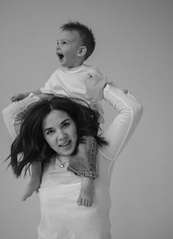 Mom rides her son on her neck photo