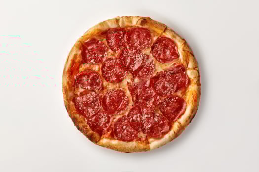 Delicious pepperoni pizza with grated parmesan lying on white background photo