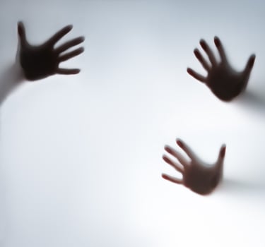 Hands reaching out from a white wall photo