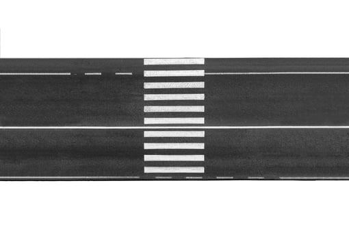 A black and white photo of a road with white lines