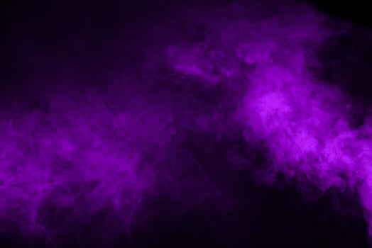 Purple smoke on a black background photo