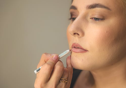 Makeup Artist Putting Powder on Young Womans Face photo