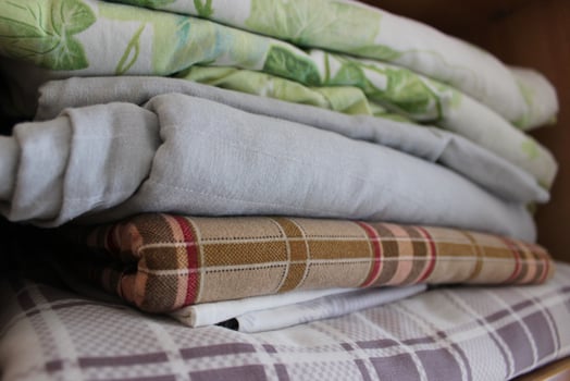 Home Wardrobe Shelf With Stacked Washed Bedclothes On It photo