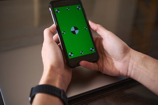 Hands Holding Smartphone With Green Screen for Digital Content Creation photo