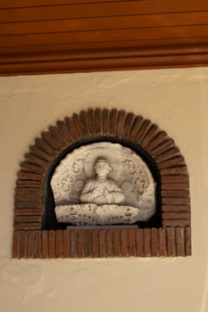 Ancient Religious Marble Relief in Brick Arch Niche photo