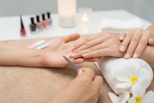 receive care service by professional Beautician Manicure at spa centre. Nail beauty salon use nail file for Glazing treatment. manicurist make nail customer to beautiful, body care spa treatment. photo