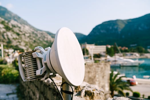 Modern Satellite Dish Overlooking Scenic Coastal Landscape photo