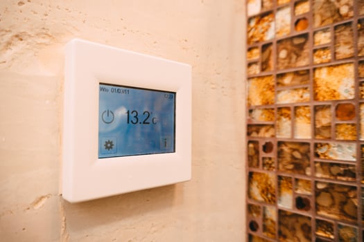Modern Digital Thermostat in Luxurious Bathroom Setting photo