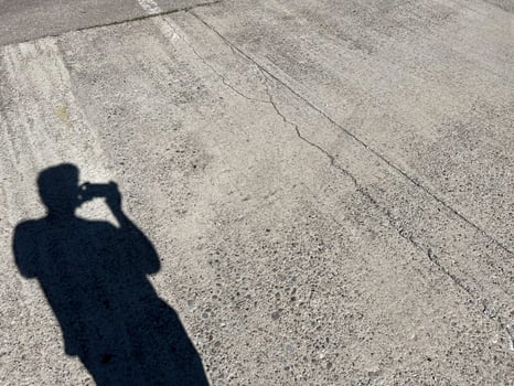 Silhouette of Photographer Taking Picture on Grungy Surface photo