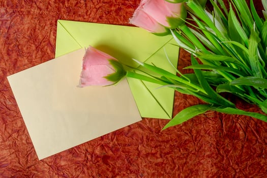 Pink roses in an envelope with a blank greeting card. photo