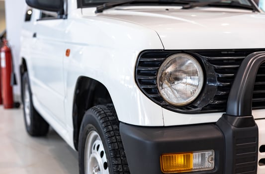A white suv parked in a showroom photo