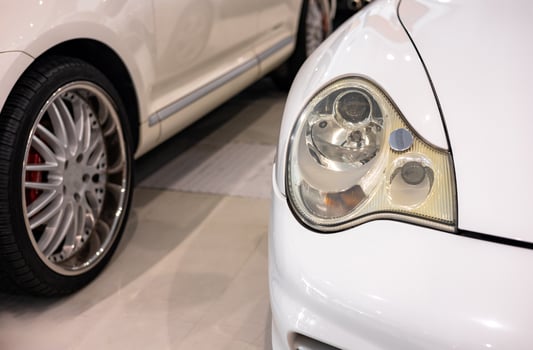 A close up of a white car with a headlight photo