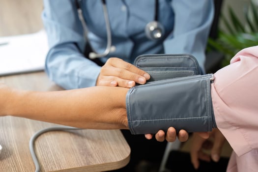 Health Monitoring and Patient Care. A healthcare professional is measuring a patients blood pressure to assess health conditions. photo