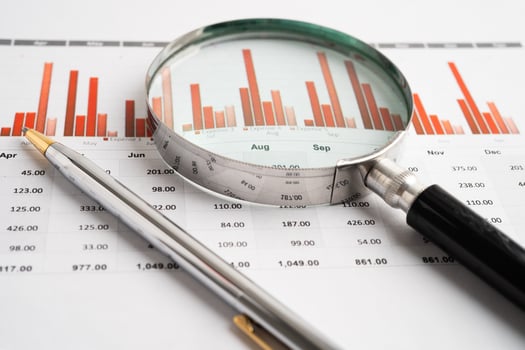 Magnifying glass on charts paper photo