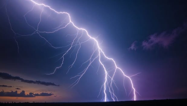 Lightning strikes over a field at dusk photo