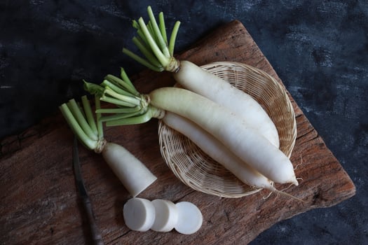 White radish on rustic wooden board. photo
