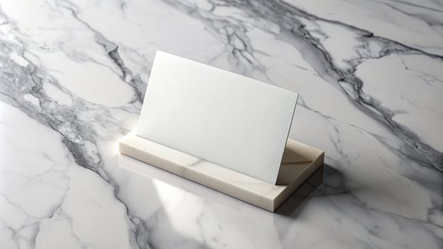 A blank card sits elegantly on a marble surface. photo