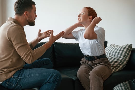 Side view of couple that are arguing... Sitting on sofa photo