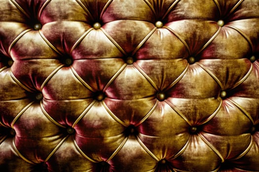 Luxurious tufted leather with rich golden tones. photo