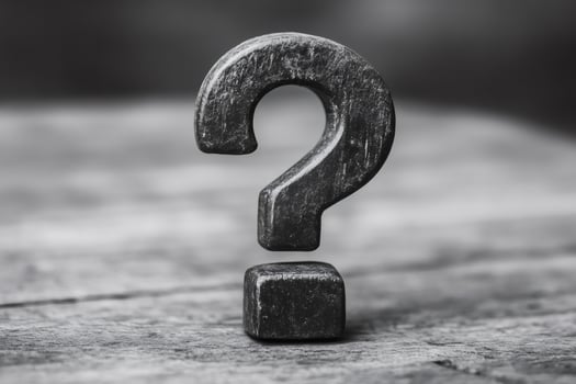 Large wooden question mark stands on rustic surface representing uncertainty photo