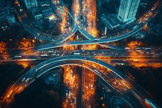 Complex highway interchange connecting busy city roads at night photo