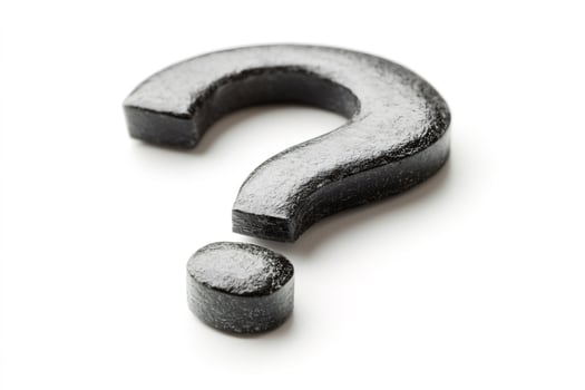 Black question mark symbol on white background posing a question photo