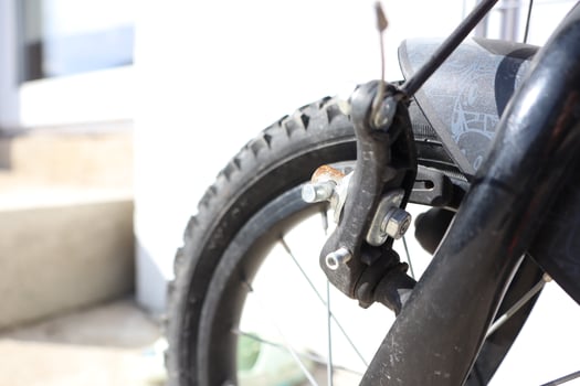 Detailed CloseUp View of a Bicycle Brake Mechanism and Wheel, Featuring Its Various Elements photo