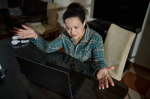 Frustrated Woman Reacting to a Laptop in a Casual Home Setting photo