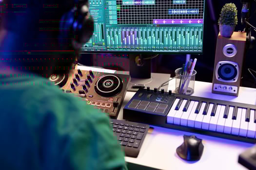 Sound engineer mixing and mastering new music on console and daw software in home studio, twisting pre amp knobs. Talented composer producing songs for the industry. Close up. photo