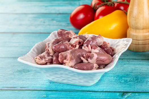 A bowl of meat with a knife and a tomato photo