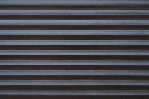 A black and white photo of a metal door