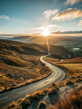 Winding road through rolling hills at sunrise. photo