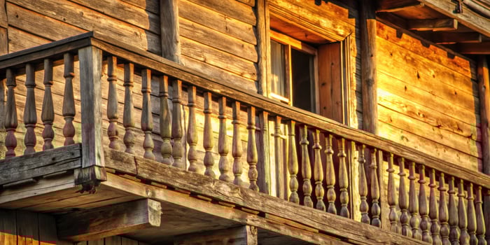 Rustic wooden balcony of a charming log cabin. photo