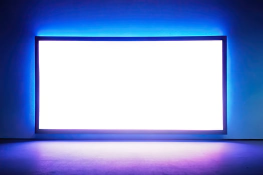 Large illuminated screen casting a blue glow. photo