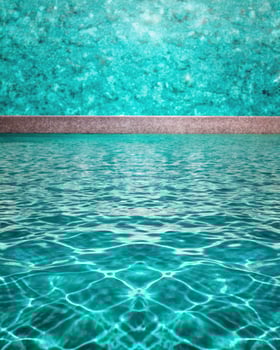 Clear turquoise swimming pool with rippling water on a sunny day photo