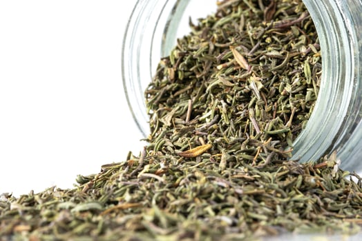 Dried French Thyme Spilled from a Spice Jar photo