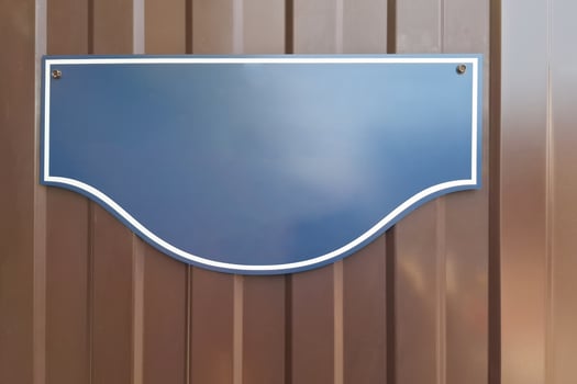 Blank blue metal sign on brown corrugated panel background photo