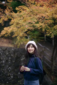 A woman standing in front of a tree photo
