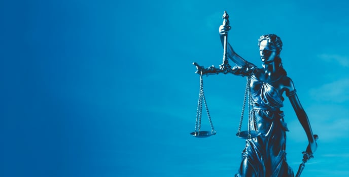 A statue of lady justice holding a scale photo