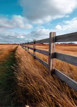 Scenic rural landscape with wooden fence open field photography bright sky wide angle view photo