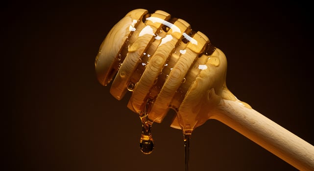 Honey Dripping From Wooden Dipper Delicious and Sweet Treat Concept photo
