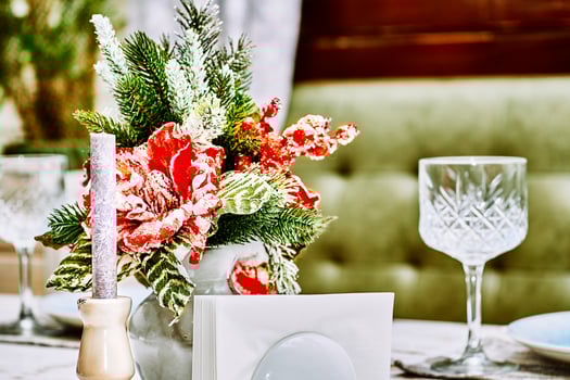 Festive New Year's Christmas table with candles and dishes close up photo